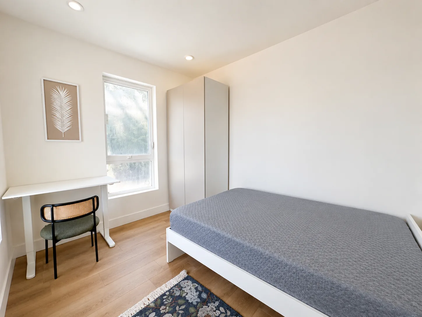 Actual Unit 202 balcony private bedroom with desk, wardrobe, and daylight